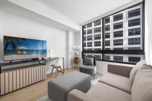 a living room with a couch and a flat screen tv at Downtown Miami - Rooftop Pool & Gym in Miami +23 photos