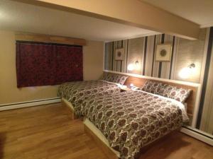 a bedroom with a bed and a large window at Galaxy Motel in St. Paul