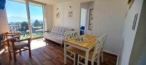 a living room with a table and a couch at Vista Insuperable in Villarrica