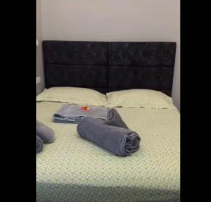 a bed with a suitcase and towels on it at Alma & Thiago House in Sharm El Sheikh