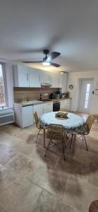 a kitchen with a table and chairs in a room at Le Donjon du Chateau in Tournissan