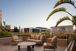a patio with chairs and tables on a balcony at Residence Inn by Marriott Antalya in Antalya