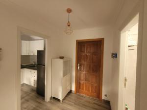 a kitchen with a refrigerator and a door at Lavilla1XO in Valverde +4 photos