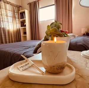 a candle on a tray on a table at LIVe in Villa Elisa