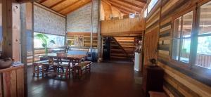 a dining room with a table and chairs in a house at Hostal Arboretum cafeteria & jardin in Hijuelas