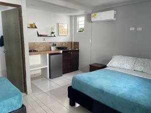 a small bedroom with a bed and a kitchen at Sarah's Place San Andres in San Andrés +62 photos