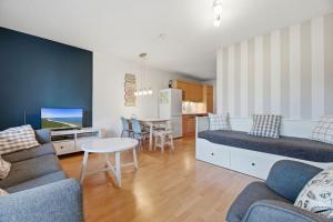 a living room with a couch and a table at Fewo Henri in Zempin