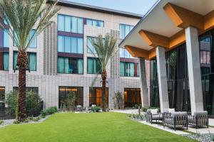 an office building with palm trees and a lawn at Element by Marriott Phoenix North Norterra in Phoenix