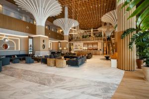 a lobby of a hotel with couches and tables at Paragraph Golf & Spa Tabori, Autograph Collection in Tbilisi City