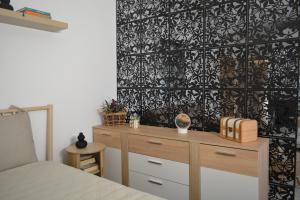 a bedroom with a dresser and a black and white wallpaper at Wolkenfrei am Sonnenhang - Moderne Wohlfühl-Oase mit sonniger Süd-Terrasse in Lebach +12 photos