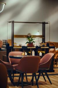 a dining room with chairs and a table in a room at Paragraph Golf & Spa Tabori, Autograph Collection in Tbilisi City +116 photos