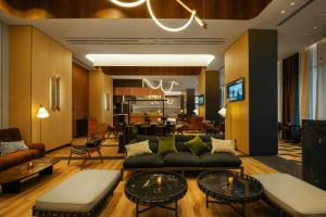 a living room with a couch and a table at Paragraph Golf & Spa Tabori, Autograph Collection in Tbilisi City