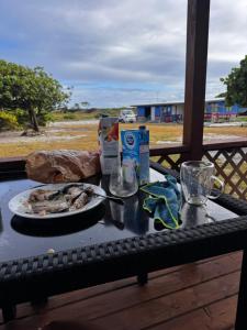 a table with a plate of food on it at Dream lodge II in Tiputa