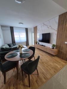 a living room with a table and a couch at Premijum 5 in Smederevska Palanka