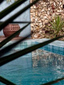 a view of a swimming pool through a glass window at Maré House in Amontada +21 photos