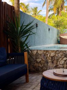 a patio with a bench and a swimming pool at Maré House in Amontada