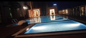 a large swimming pool on top of a building at night at Singh Royal stay in Lucknow +8 photos