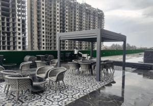 a patio with tables and chairs on a roof at Singh Royal stay in Lucknow
