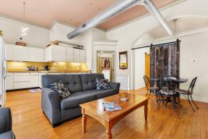 a living room with a couch and a table at Historic Loft w/ Private Deck, 2 Blocks to Dtwn in Saugatuck