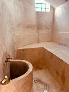 a bathroom with a large tub and a sink at Riad Blue Berry & SPA in Marrakesh
