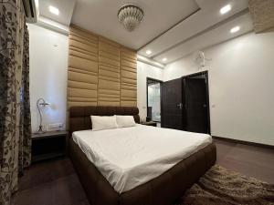 a bedroom with a large bed in a room at Joyous stay in Jaipur