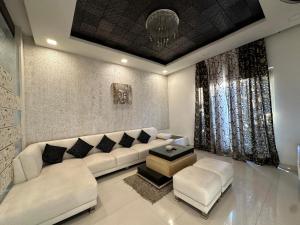 a living room with a white couch and a table at Joyous stay in Jaipur