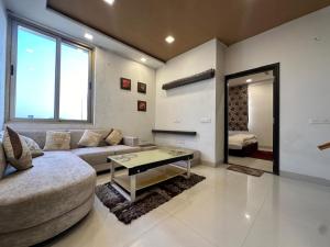 a living room with a couch and a table at Joyous stay in Jaipur