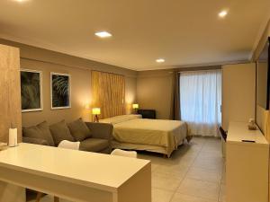 a hotel room with a bed and a couch at 4 Estaciones in El Bolsón