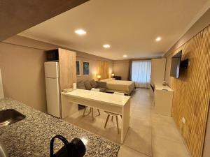 a room with a kitchen and a living room at 4 Estaciones in El Bolsón