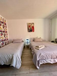 two beds sitting next to each other in a bedroom at Jupiter Sea View in Benalmádena +12 photos