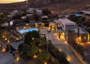 an aerial view of a building with a pool at night at Relax Joy Villa | Koundouros Kea Beachside in Koundouros +47 photos