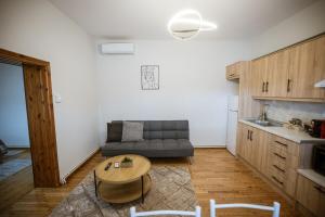 a living room with a couch and a table at Riverside Escape ,modern residence with courtyard in Florina +17 photos