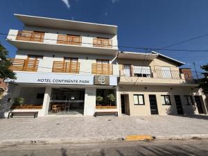 a building with a hotel committee pay sign in front of it at Apart Continente Park in San Clemente del Tuyú