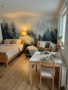a bedroom with a bed and a table and a couch at Wohlfühlapartment GUXHAGEN- nähe Bahnhof & A7, schnell in Kassel in Guxhagen