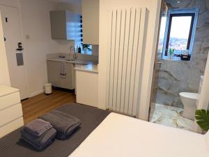 a bedroom with a bed with two pillows on it at Studio Flat in New Barnet in New Barnet