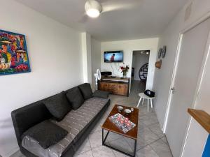 a living room with a couch and a table at Maryvent Apartment in Sainte-Anne