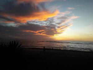 a person standing on the beach at sunset at Casa de los Artistas in Marbella