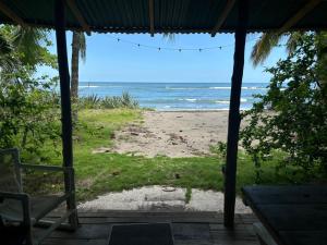 a view of the beach from the porch of a beach house at Casa de los Artistas in Marbella
