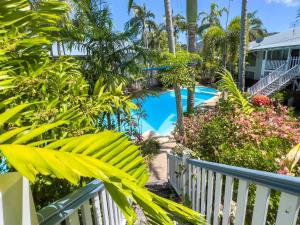 a view of the pool from the balcony of a resort at Island Glow in Airlie Beach