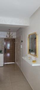 a room with a hallway with a mirror and a door at ADORA Apartment in Tangier +5 photos