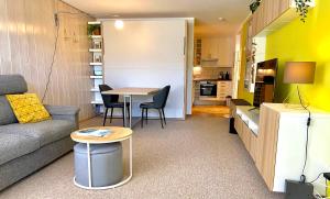 a small living room with a couch and a table at Ferienwohnung Kirchbichl am Schliersee mit Terrasse in Schliersee +7 photos