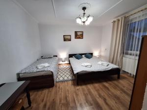 a small room with two beds and a window at Bieszczadzka Chata Stańkowa in Ropienka