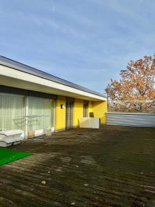 a yellow building with a large yard next to it at Private 5 bedroom for large Groups in Hunzenschwil