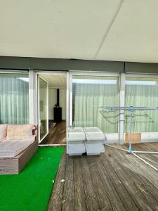 a living room with a couch and green carpet at Private 5 bedroom for large Groups in Hunzenschwil