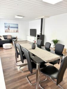 a dining room with a table and chairs at Private 5 bedroom for large Groups in Hunzenschwil