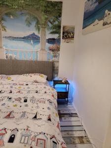 a bedroom with a bed with a painting on the wall at ElE G Holiday let's Bridlington in Bridlington