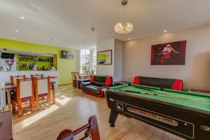 a living room with a pool table and a bar at New Promenade Hotel in Blackpool