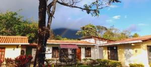 a house with a rainbow in the background at Cabañas DondeJosé in Valle de Anton