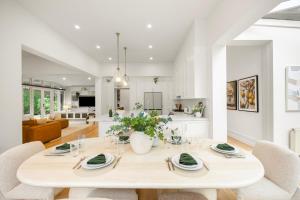 a kitchen and dining room with a table and chairs at Complete Host Brighton House in Melbourne +22 photos