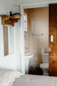 a bathroom with a toilet and a sink at Chalé Romântico em Itamonte-MG in Itamonte